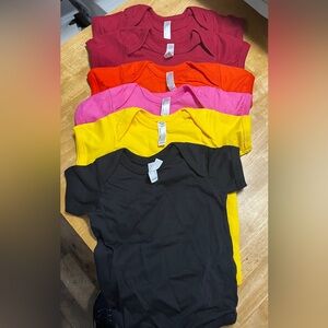 A Lot of 6. These are 18 mos sized baby onesies. The brand is Rabbit Skin.